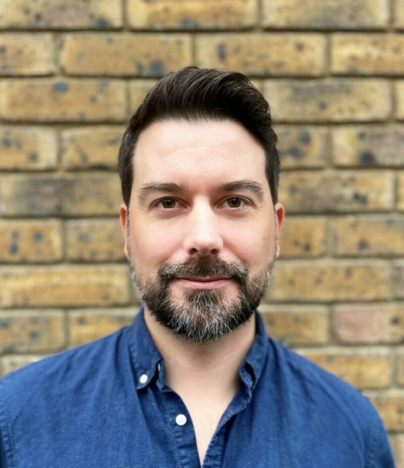 Headshot of Antony Cousins looking into the camera