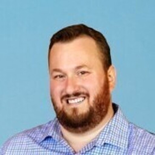 Portrait of Evan Ahlers, smiling towards the camera